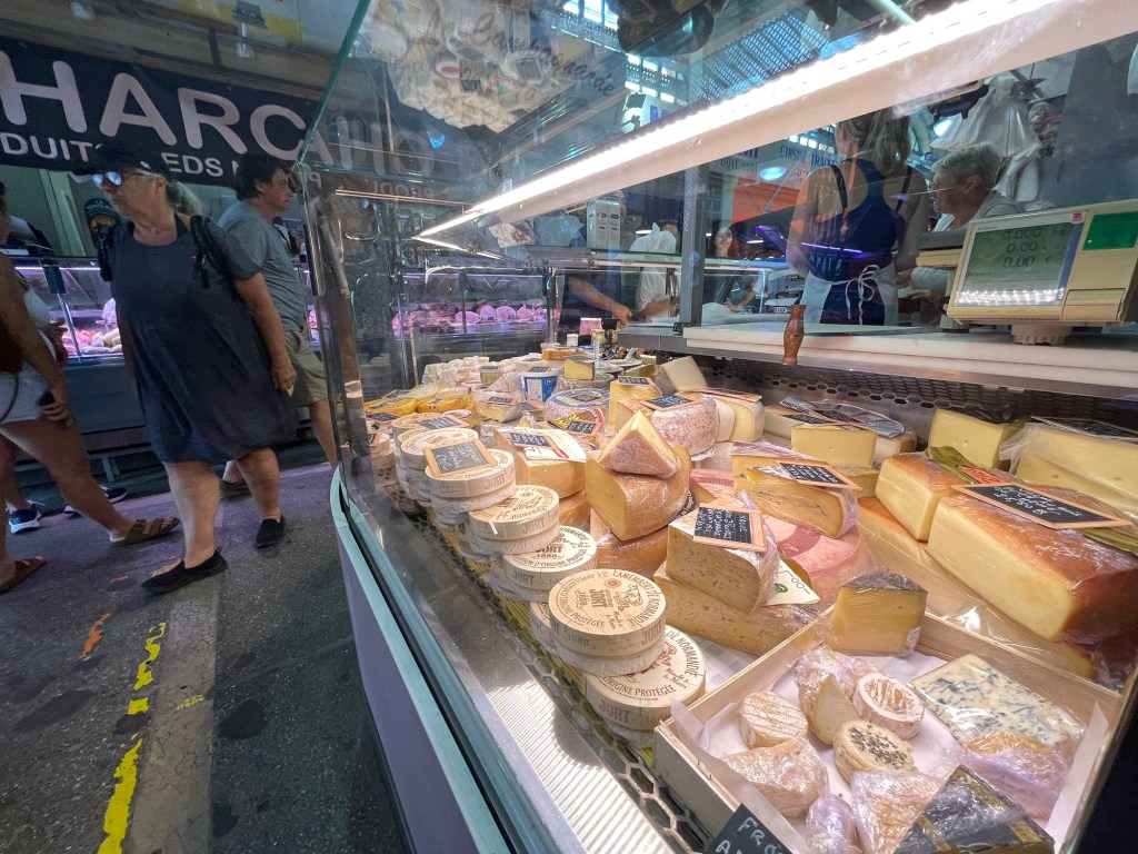 A cheese counter with a dizzying variety of cheeses 